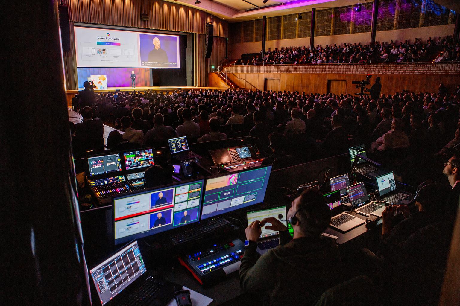 Front of house direction desk overlooking a packed auditorium during a live show